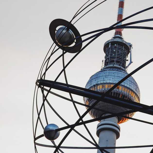 The Berlin TV tower seen through the World Clock monument at Alexanderplatz